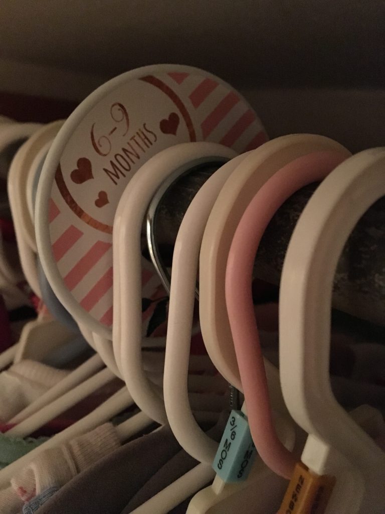 Closet dividers separate baby clothing by month.