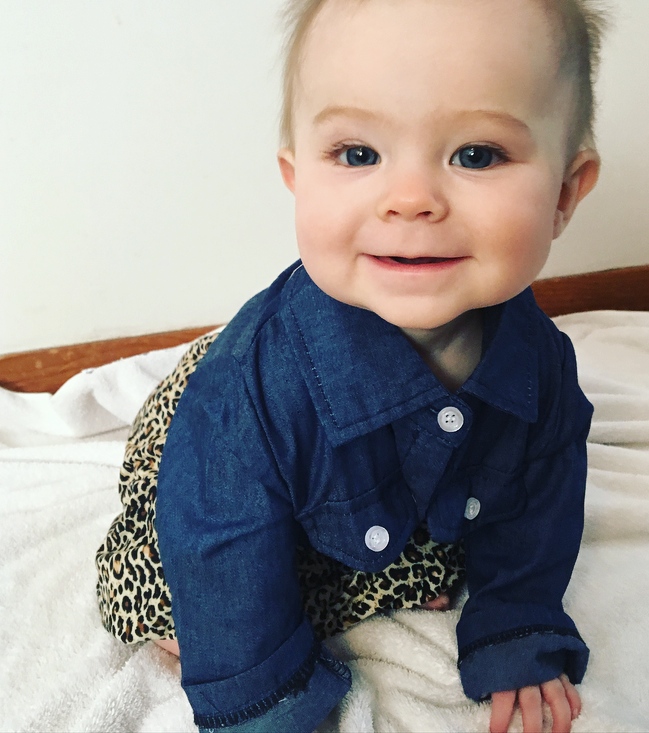 Little girl wears skirt with leopard print and denim top.