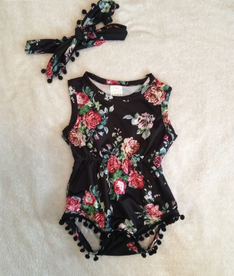 Little girl black romper with floral print.
