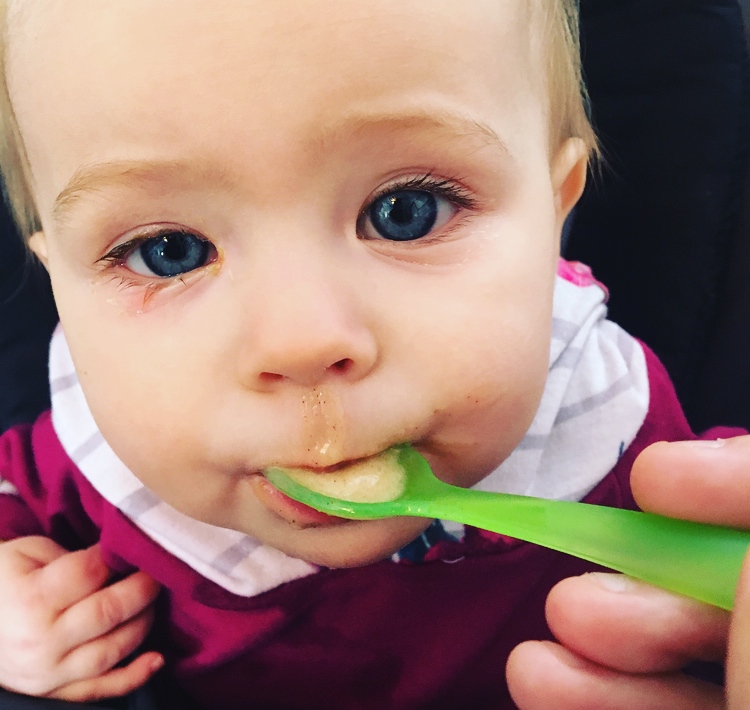 Teething baby eats breast milk ice cream.