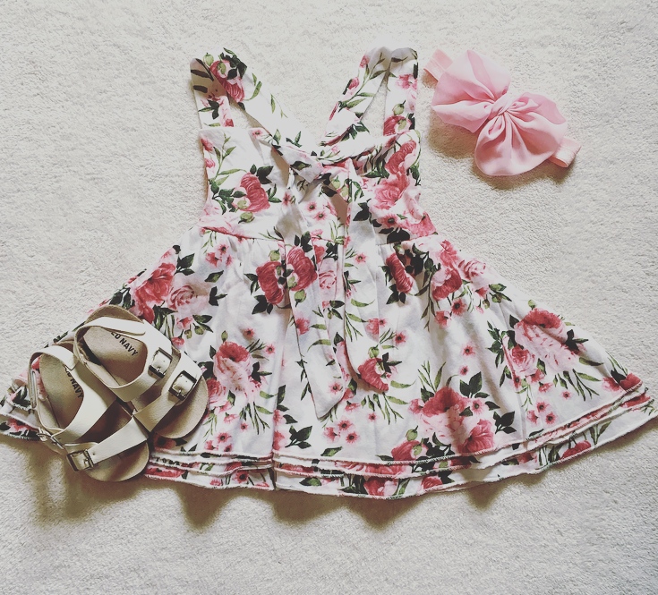 White dress with pink and green flower print for girls.