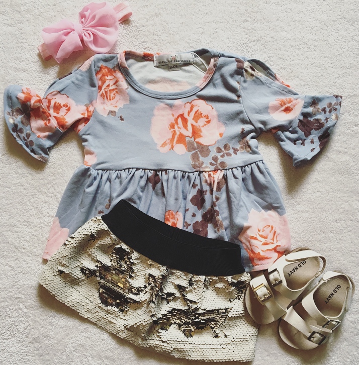 Blue top with orange flowers and shorts outfit for little girl.