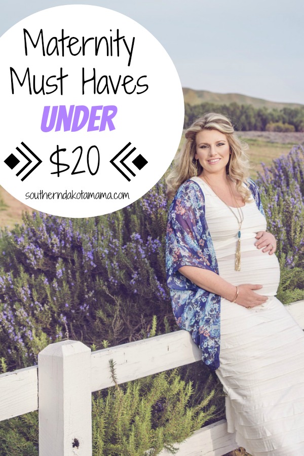 Pinterest graphic with text for Maternity Must Haves and pregnant woman sitting on fence in front of lavender field.
