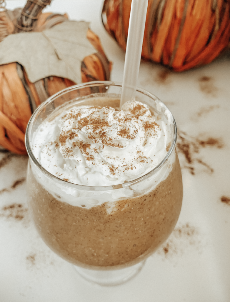 Smoothie with pumpkin spice in clear glass.