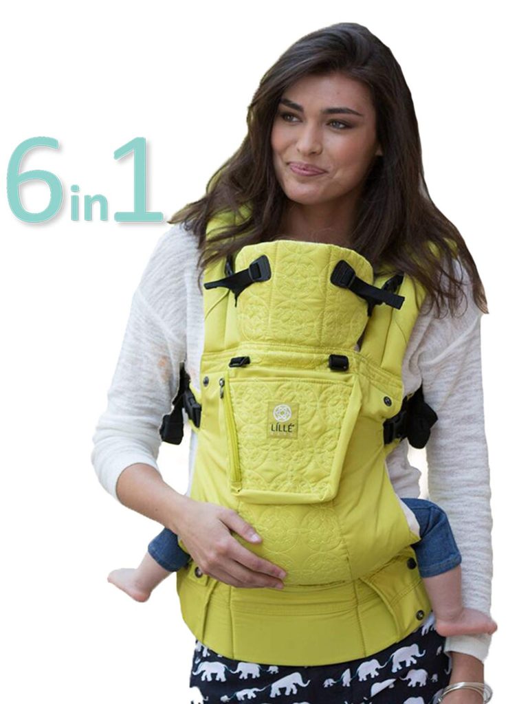 Woman models yellow 6 in 1 baby carrier with small child.