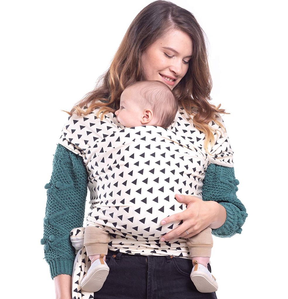 Woman models black and white baby sling with small child.