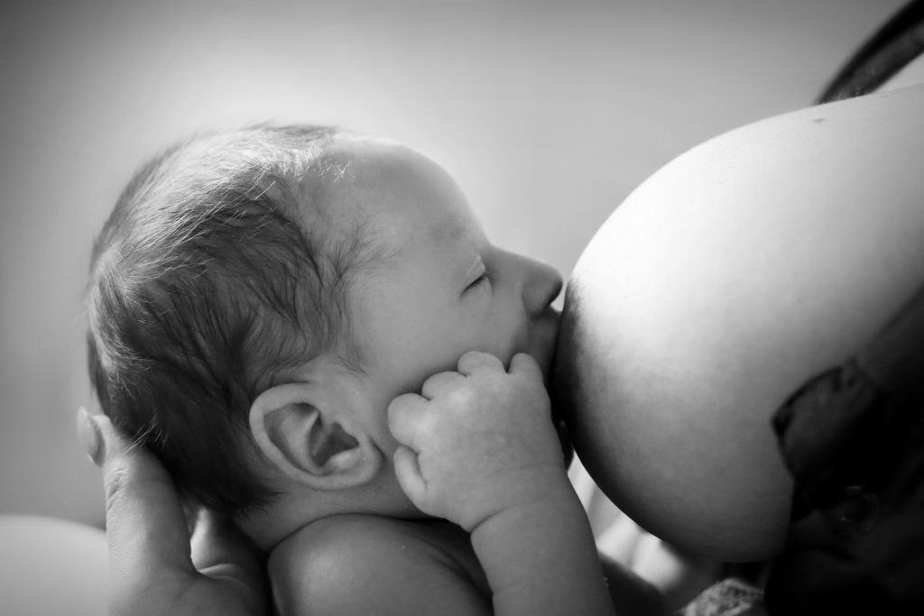 Black and white image of breastfeeding baby.